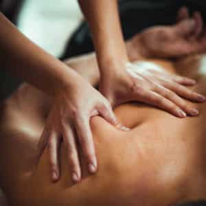 Close-up of a relaxing back massage, highlighting professional hands applying pressure for muscle recovery and relaxation.