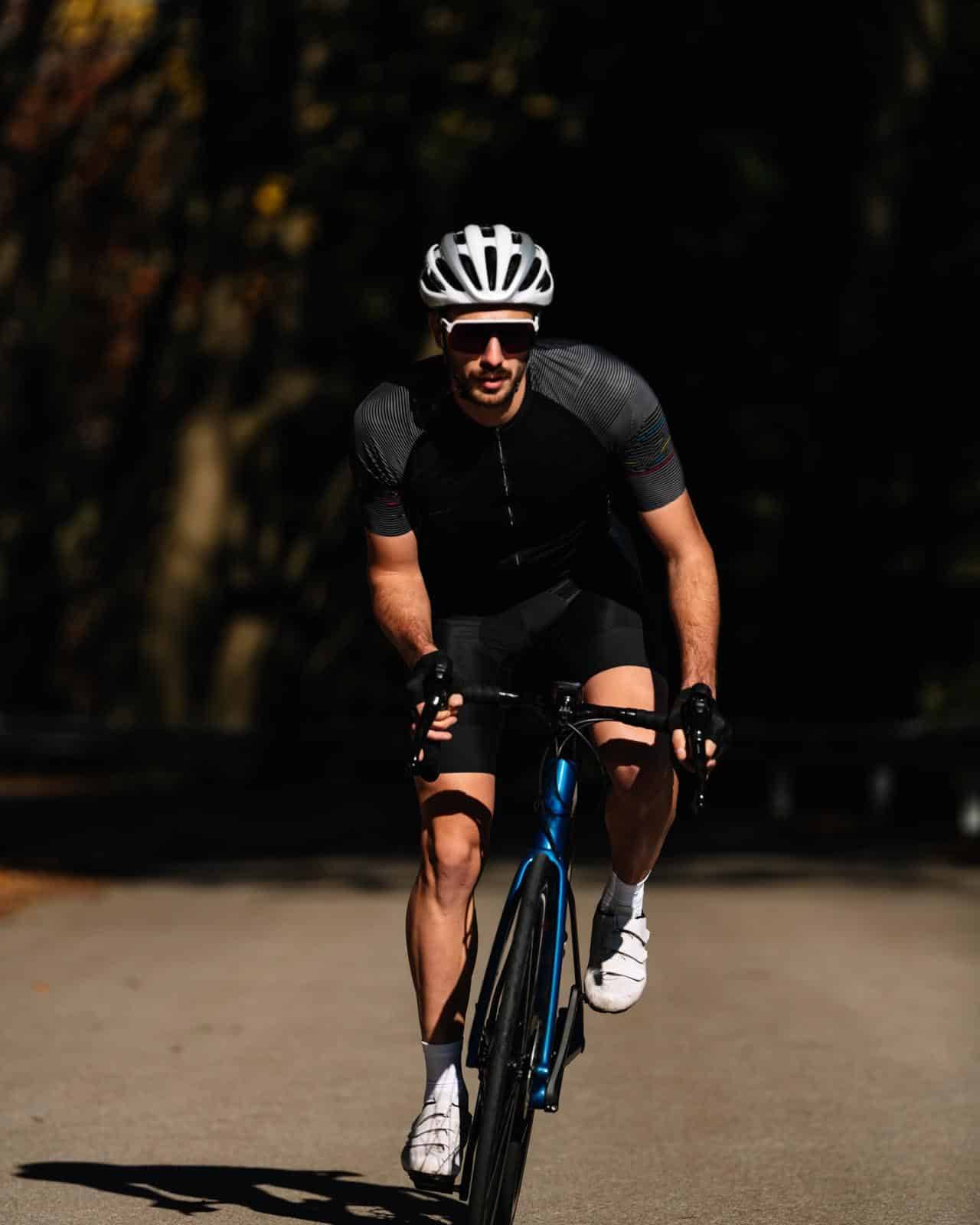 Cyclist riding a bike on a curved road in autumn scenery. sport concept