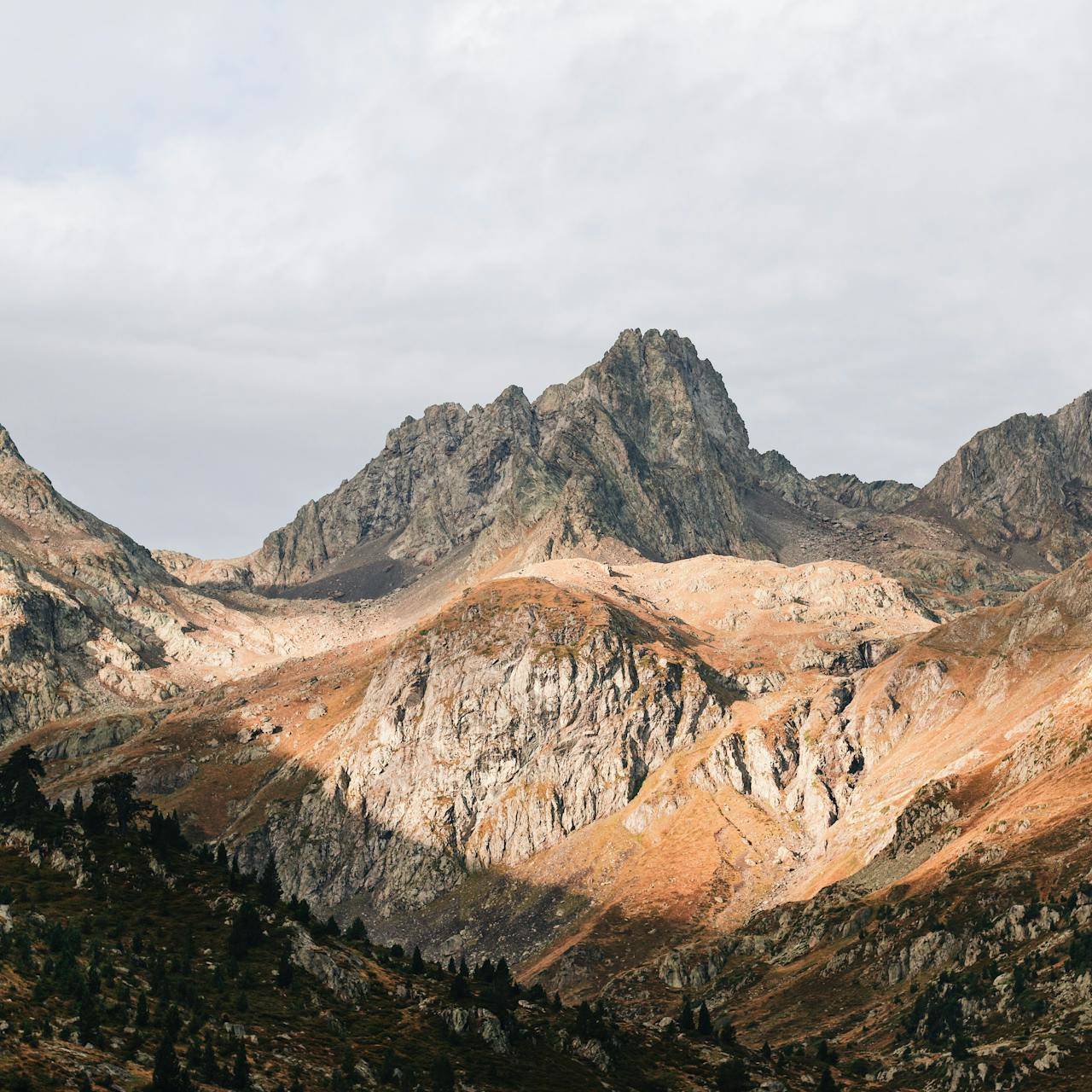 Views of a rocky mountains range in the Pyrenees under the setting sun.