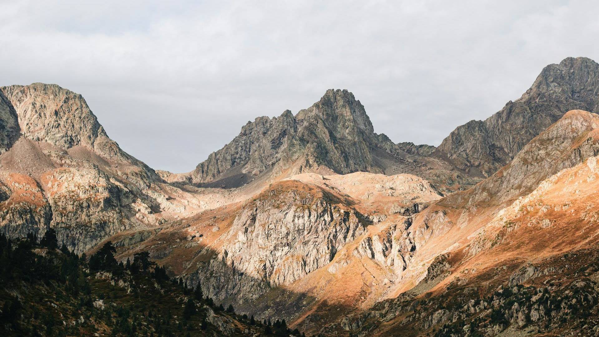 Views of a rocky mountains range in the Pyrenees under the setting sun.