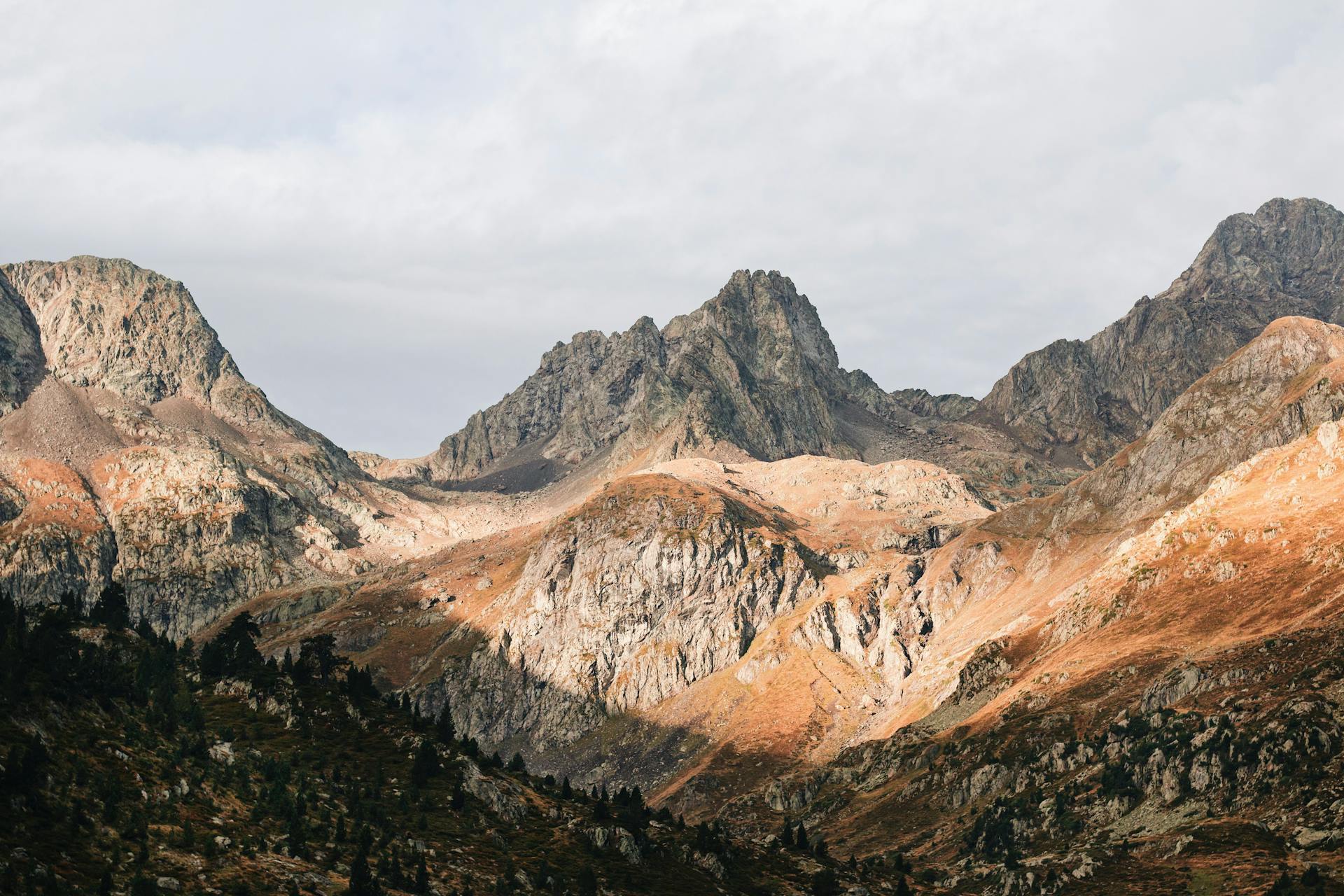 Views of a rocky mountains range in the Pyrenees under the setting sun.