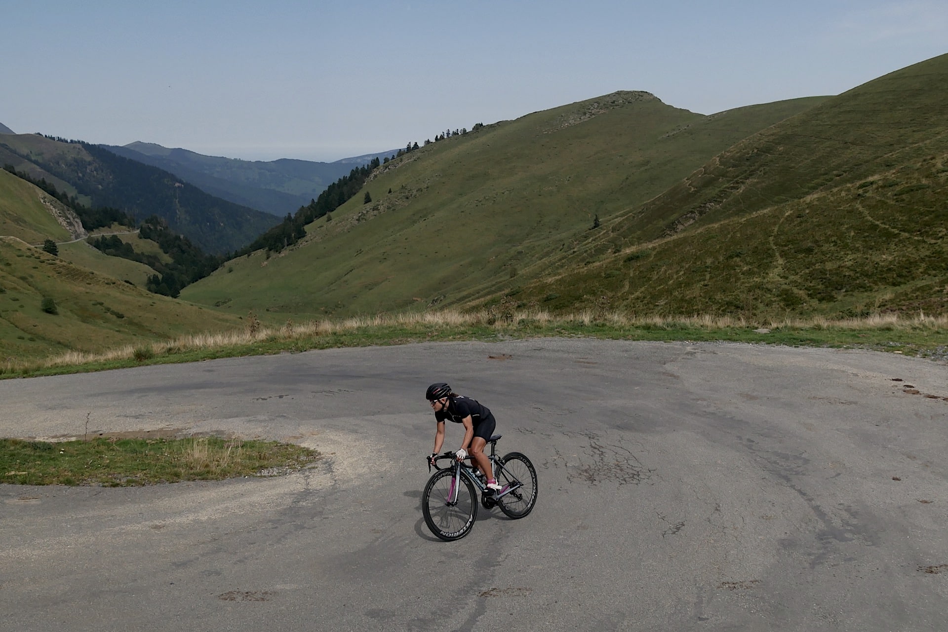 Best cycling climbs in the Pyrenees. A cycling ascending on the slopes of the Port de Bales under blue skies.